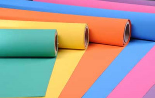 Green, Yellow, Orange, Blue, Pink, and Purple Rubber Sheets Half Unrolled