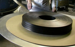 Rubber Extrusions Rolled Straight From Production Into a Pan for Vulcanization.
