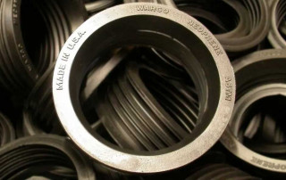 Beige Rubber Molded Gaskets With Stenciled Words "Made in the USA" "WARCO" "Neoprene" "ASTM"